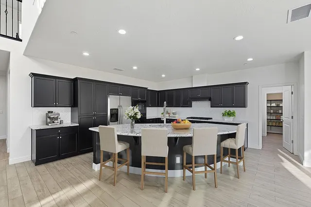 a large kitchen with a table and chairs in it