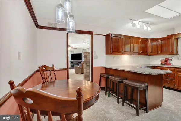 a view of a dining room with furniture wooden floor and chandelier