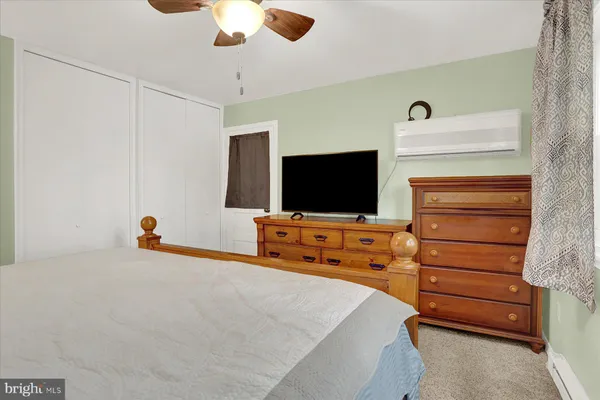 a living room with flat screen tv and a kitchen island