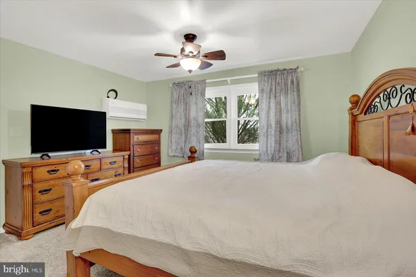 a bed sitting in a room next to a lamp