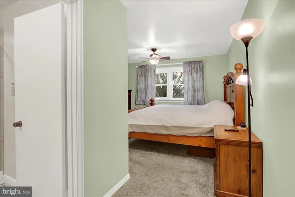 a bathroom with a granite countertop sink a toilet and shower