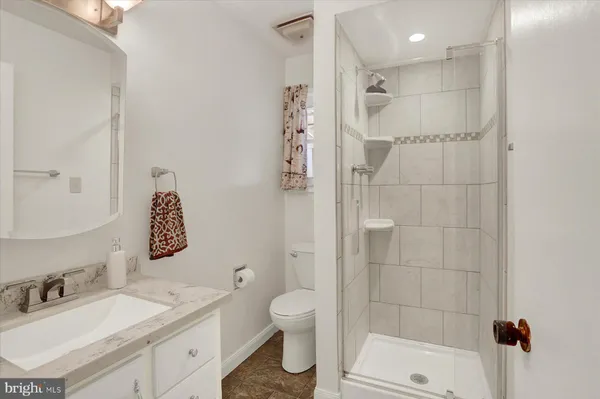 a bathroom with a shower a toilet and a sink