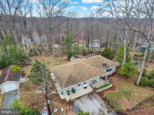 an aerial view of a house with yard and patio