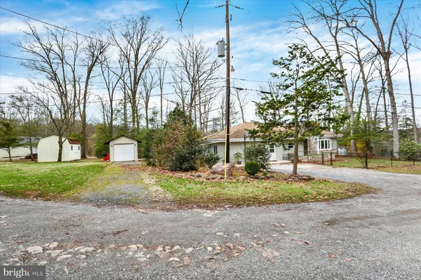 an aerial view of a house with yard and trees