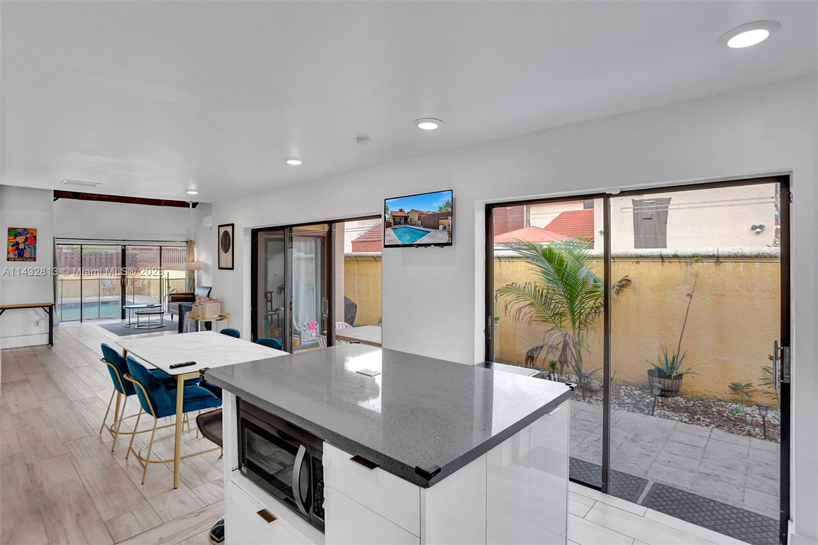 20429 Northeast 10th Ct Road Miami, FL 33179 - Photo 14 of 42 a view of a dining room with furniture window and wooden floor
