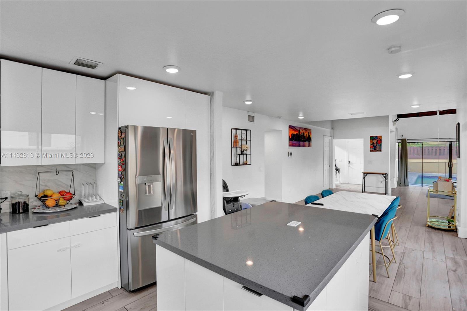 20429 Northeast 10th Ct Road Miami, FL 33179 - Photo 15 of 42 a open kitchen with stainless steel appliances granite countertop a refrigerator and a sink