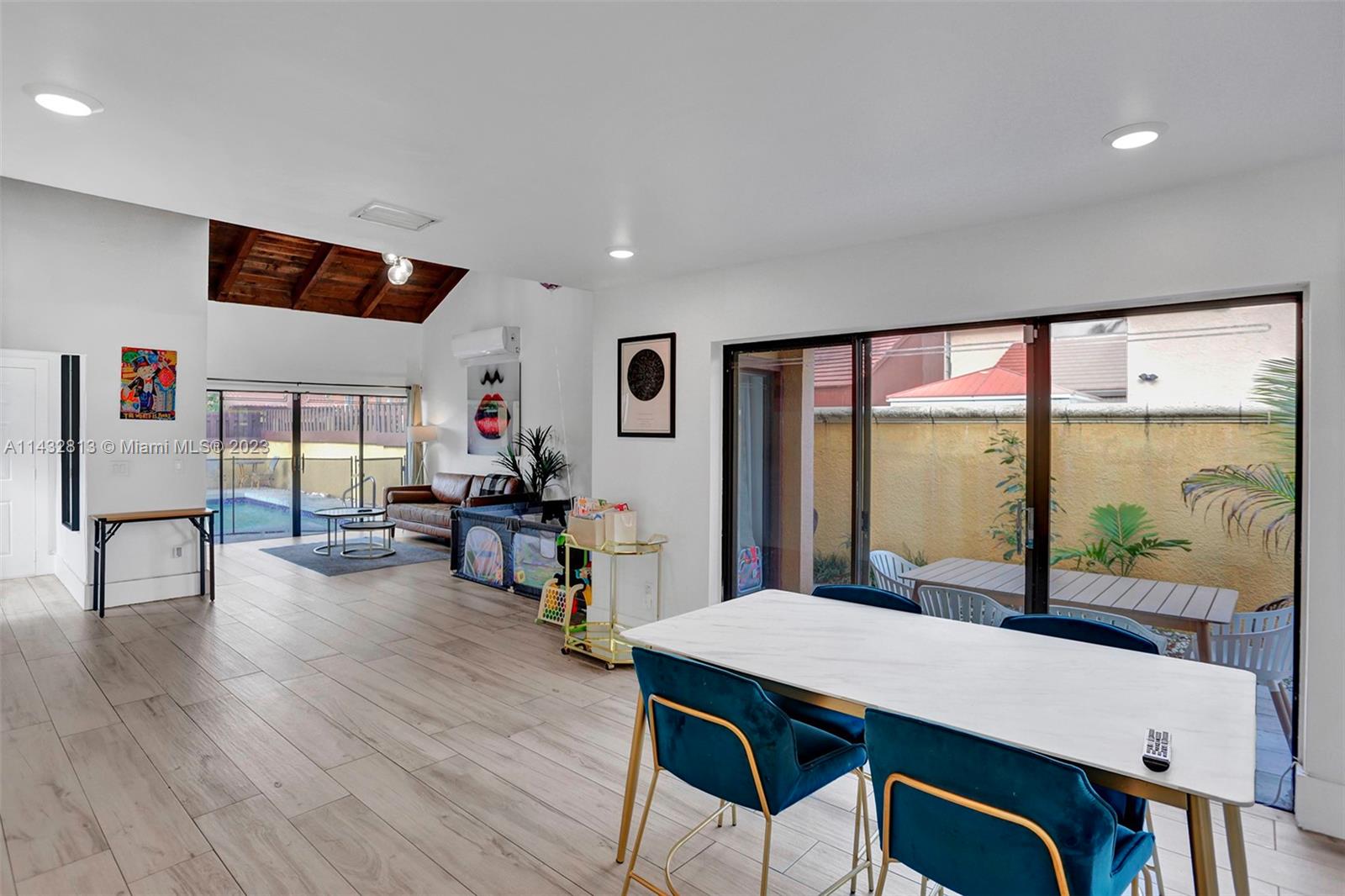 20429 Northeast 10th Ct Road Miami, FL 33179 - Photo 17 of 42 a view of a dining room with furniture window and wooden floor