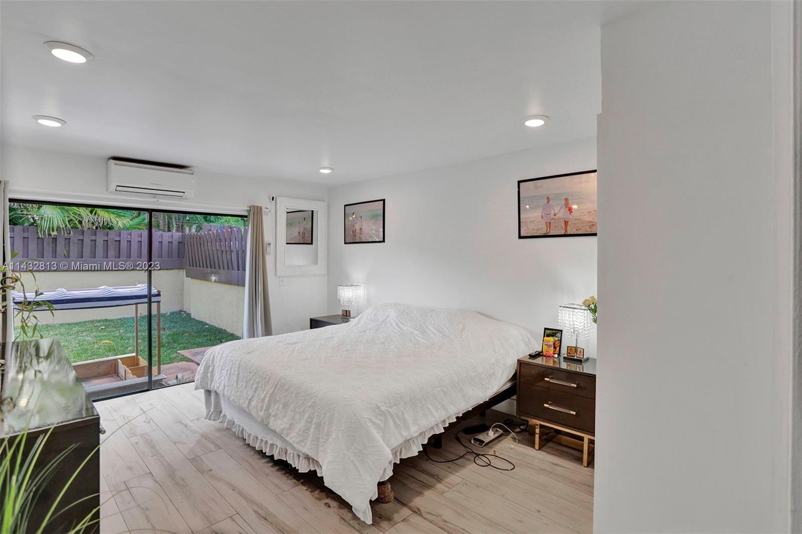 20429 Northeast 10th Ct Road Miami, FL 33179 - Photo 23 of 42 a bedroom with a bed and a large window