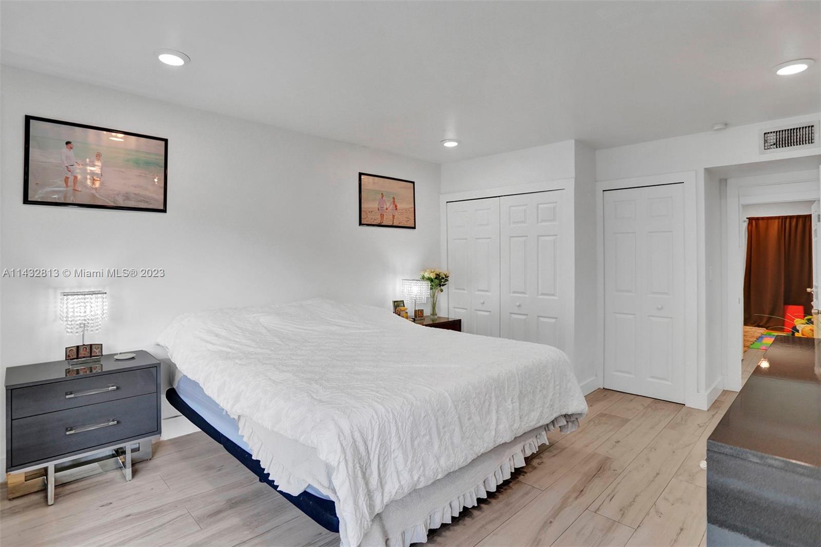 20429 Northeast 10th Ct Road Miami, FL 33179 - Photo 24 of 42 a bedroom with bed and night stand