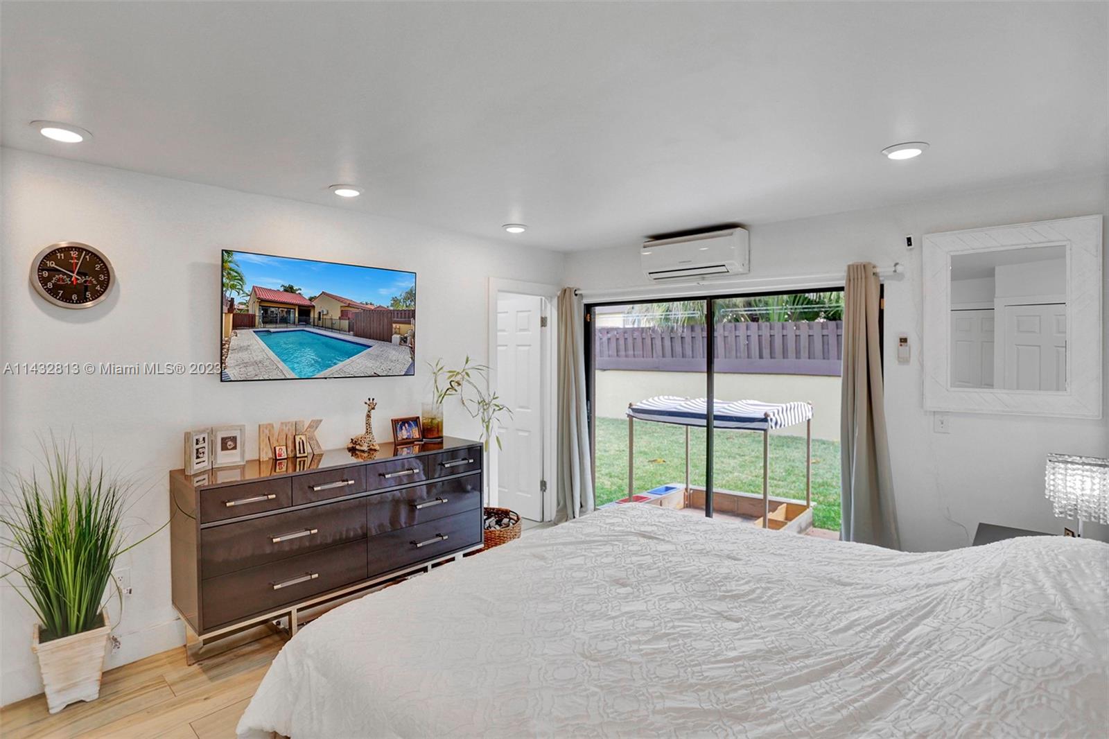 20429 Northeast 10th Ct Road Miami, FL 33179 - Photo 25 of 42 a bedroom with a bed and a flat screen tv