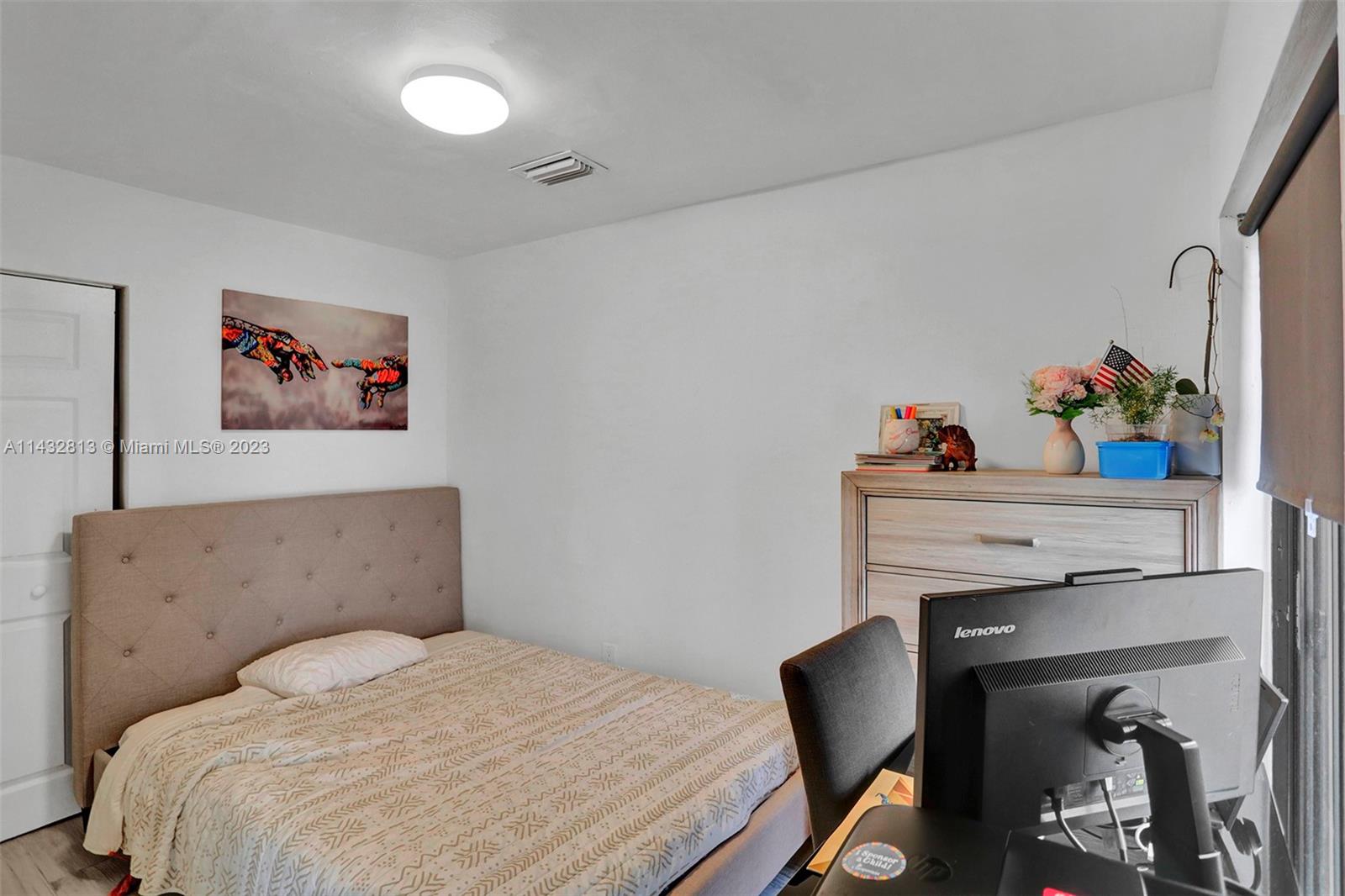 20429 Northeast 10th Ct Road Miami, FL 33179 - Photo 28 of 42 a bedroom with a bed and a chair