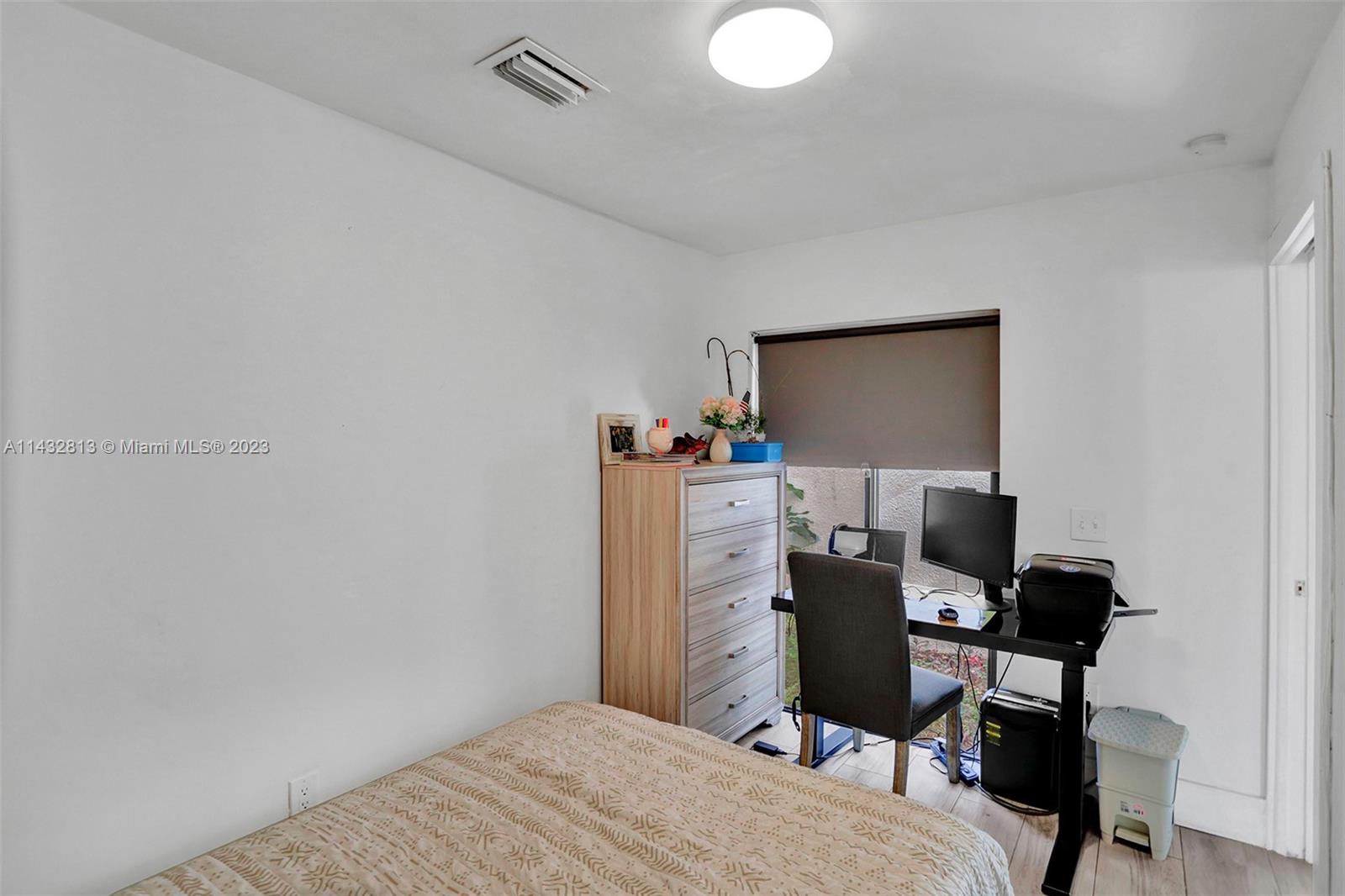 20429 Northeast 10th Ct Road Miami, FL 33179 - Photo 29 of 42 a bedroom with a workspace