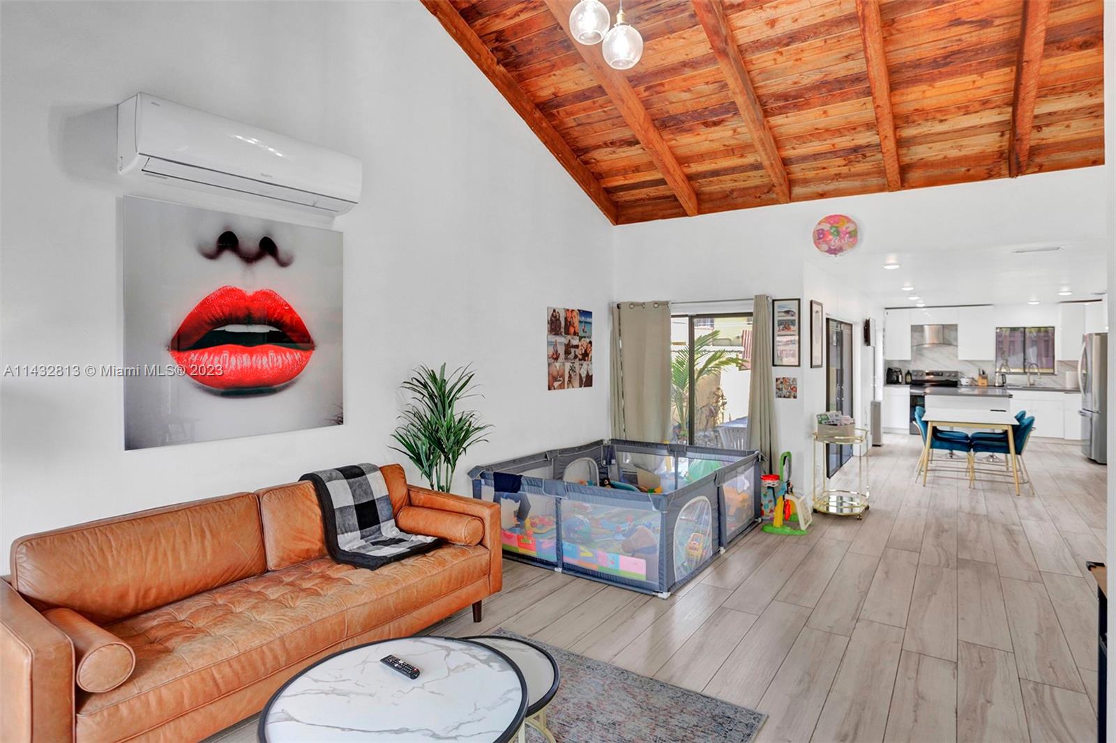 20429 Northeast 10th Ct Road Miami, FL 33179 - Photo 9 of 42 a living room with furniture a rug and white walls