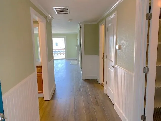 a view of a hallway with wooden floor