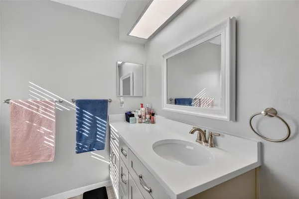 a bathroom with a sink vanity and a mirror