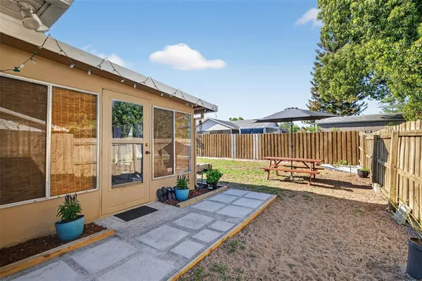 a view of a deck with chairs and potted plants