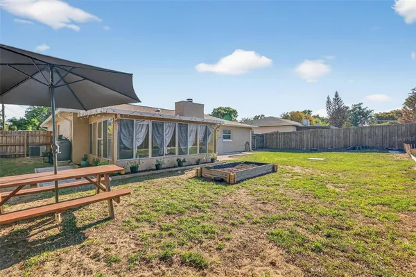 a swimming pool with outdoor seating and yard