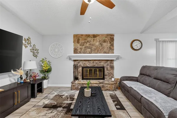 a living room with furniture a fireplace and window