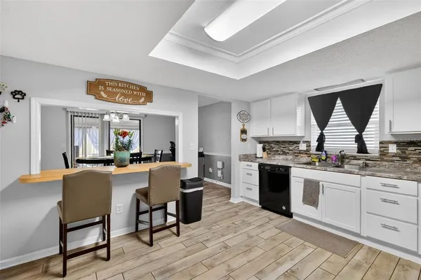 a kitchen with a sink cabinets and window