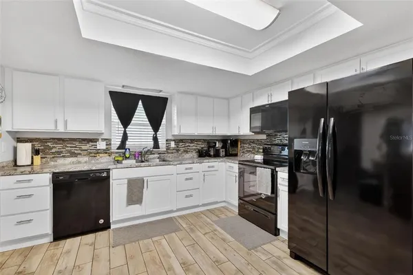 a kitchen with stainless steel appliances granite countertop a stove and a refrigerator