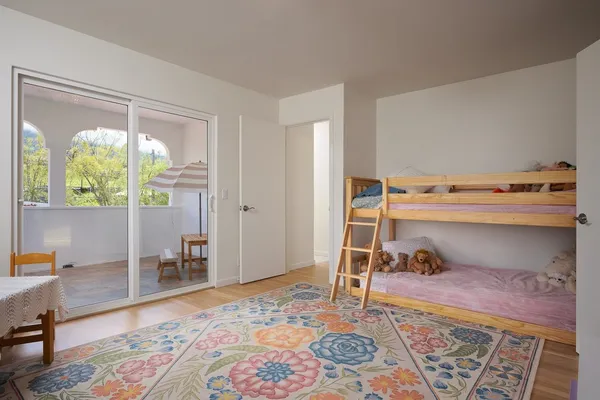 a bedroom with a bed and wooden floor