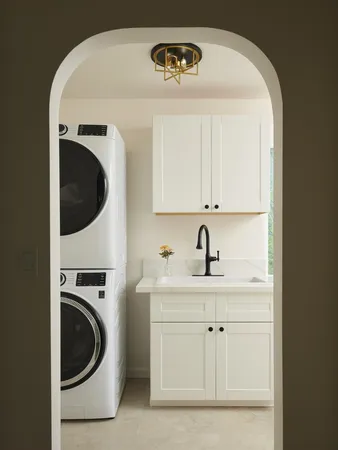 a utility room with sink dryer and washer