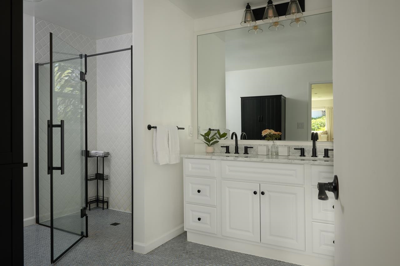 Undisclosed Address Kula, HI 96790 - Photo 30 of 50 a bathroom with a double vanity sink and mirror
