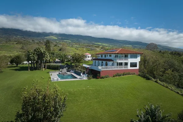 a view of a big yard with a house in the background