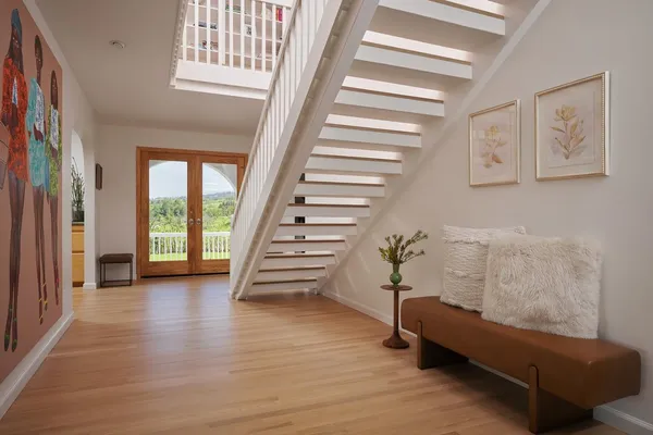 a view of entryway with stairs and wooden floor