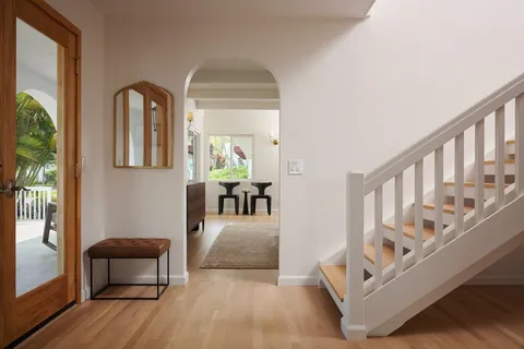 a view of entryway and hall with wooden floor