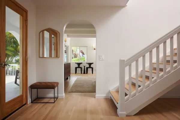 a view of entryway and hall with wooden floor