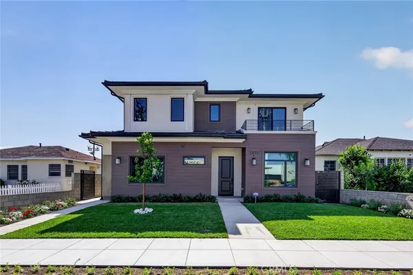 a front view of a house with a garden