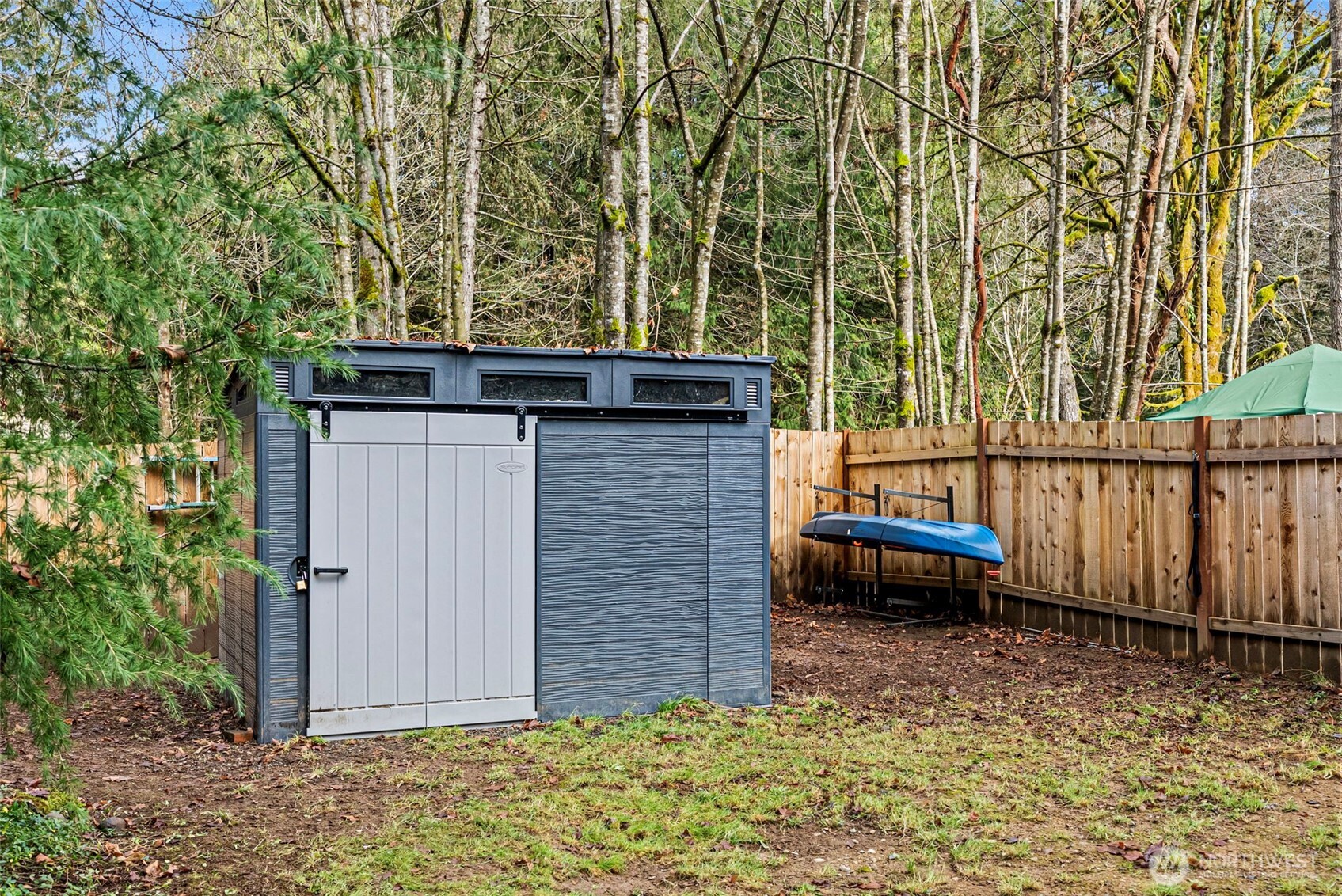 721 East McMickin Road Shelton, WA 98584 - Photo 28 of 38 a backyard of a house with a bench and wooden fence