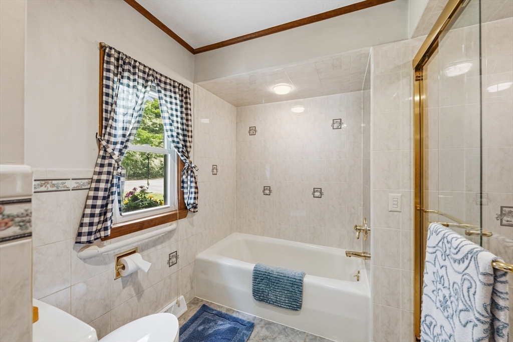 43 Flint Road Tyngsborough, MA 01879 - Photo 16 of 40 a bathroom with a bathtub and a shower