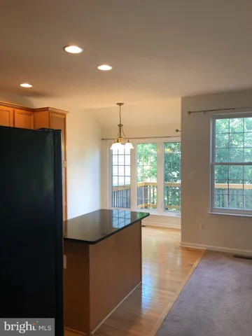 a kitchen with counter top and living room