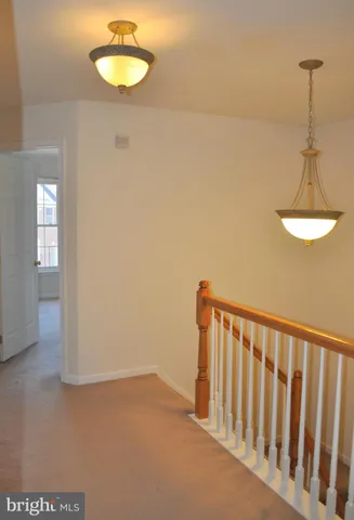 a view of a room with a mirror and a ceiling fan