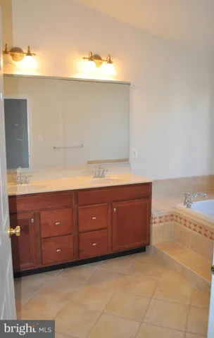 a bathroom with a tub and vanity