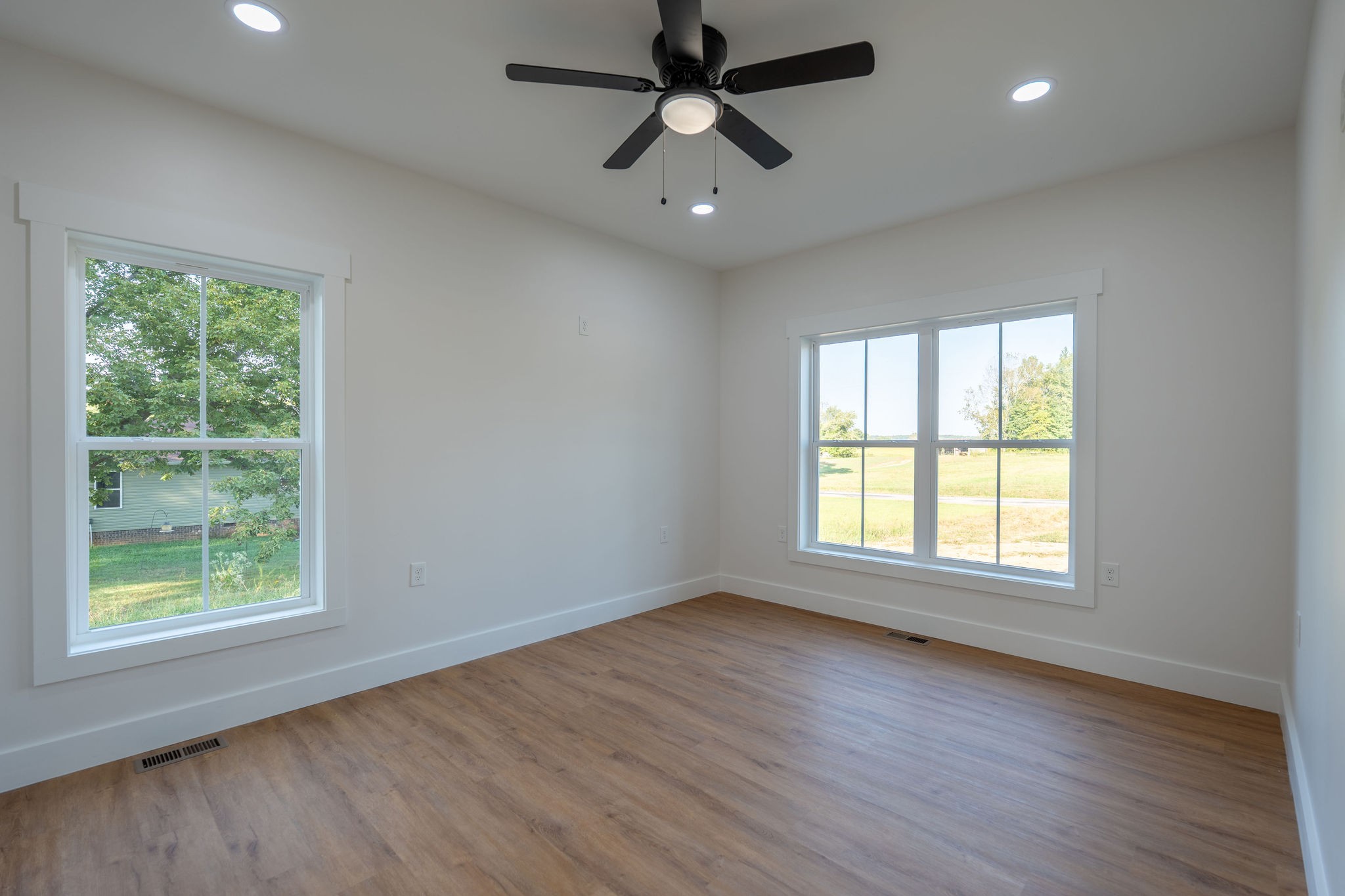 1166 Dugout Road Summertown, TN 38483 - Photo 13 of 24 a view of an empty room with wooden floor and a window