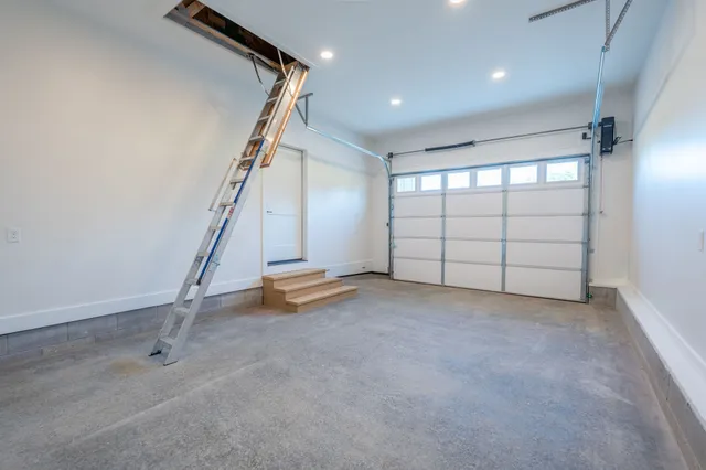 a view of a room with stairs and white walls
