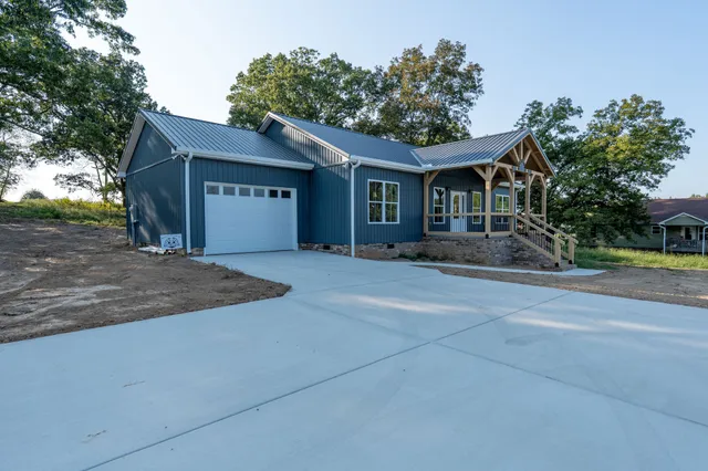 a front view of a house with a yard and a garage