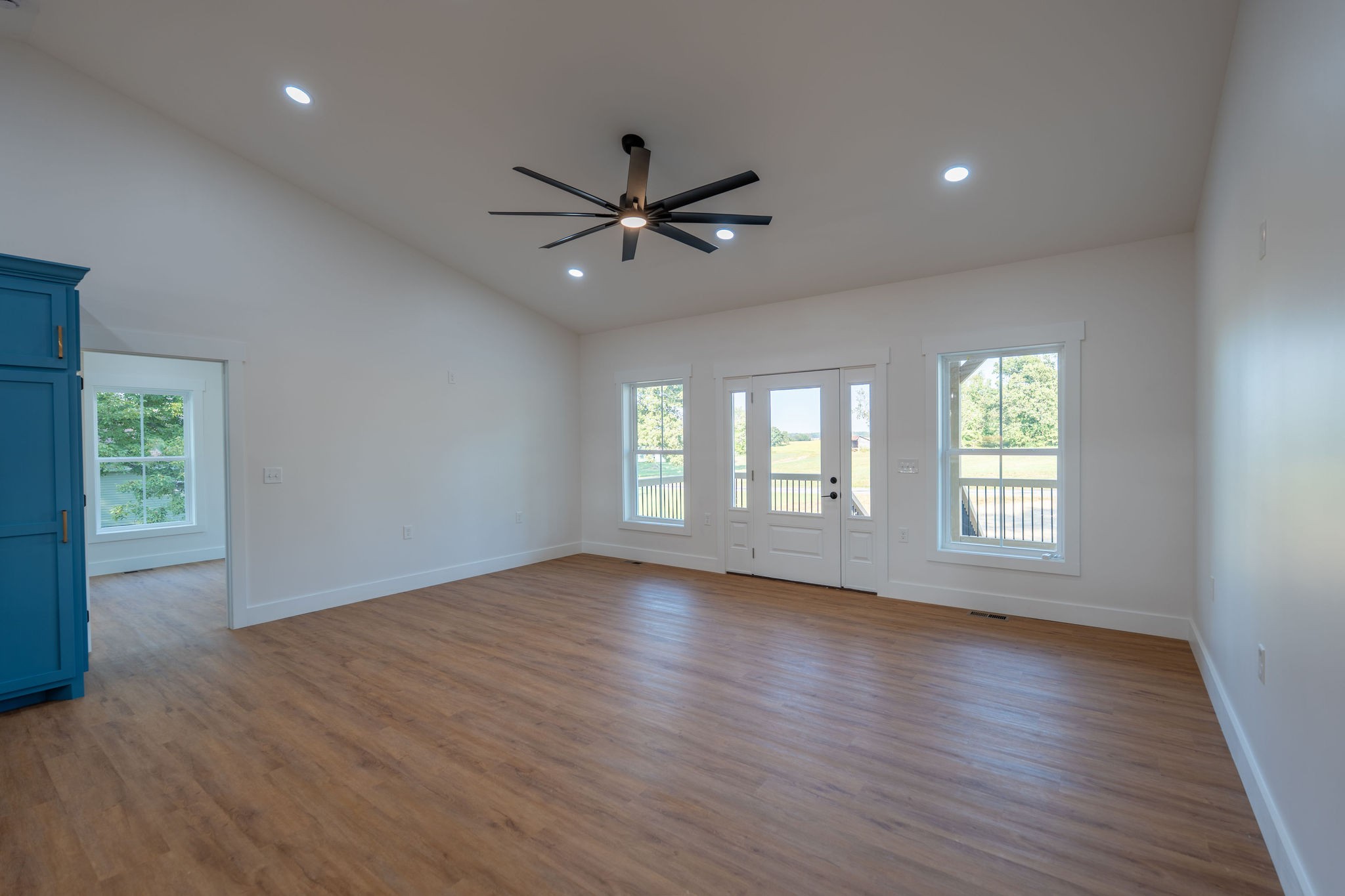 1166 Dugout Road Summertown, TN 38483 - Photo 6 of 24 a view of an empty room with wooden floor and a window