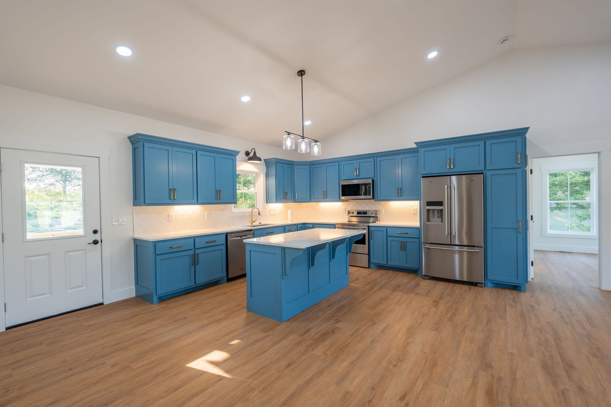 1166 Dugout Road Summertown, TN 38483 - Photo 9 of 24 a kitchen with stainless steel appliances wooden floors and wooden cabinets