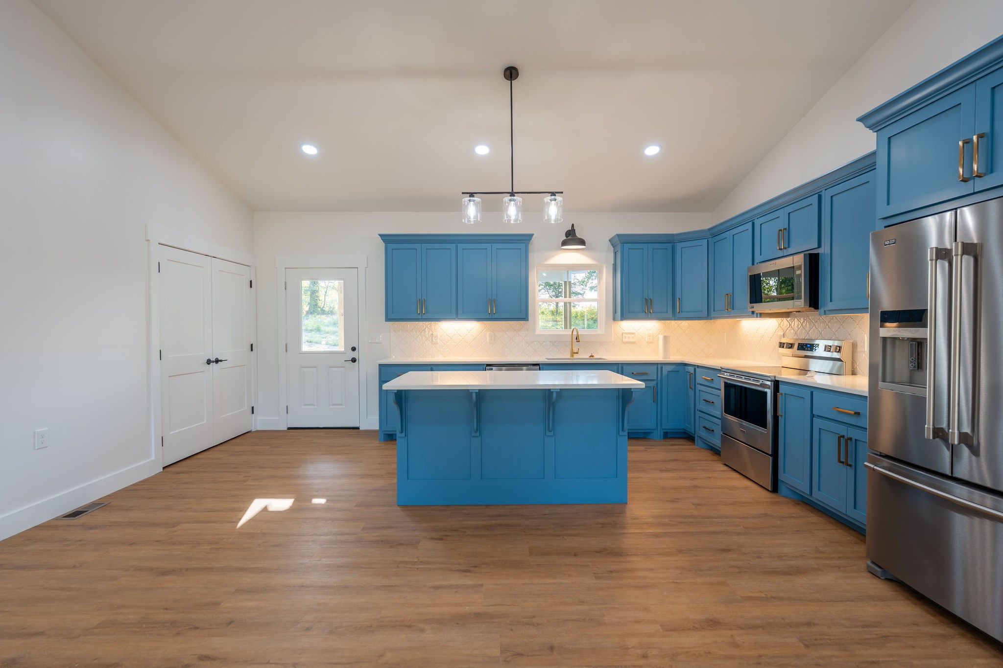 1166 Dugout Road Summertown, TN 38483 - Photo 10 of 24 a large kitchen with stainless steel appliances kitchen island granite countertop a large counter top and wooden floors