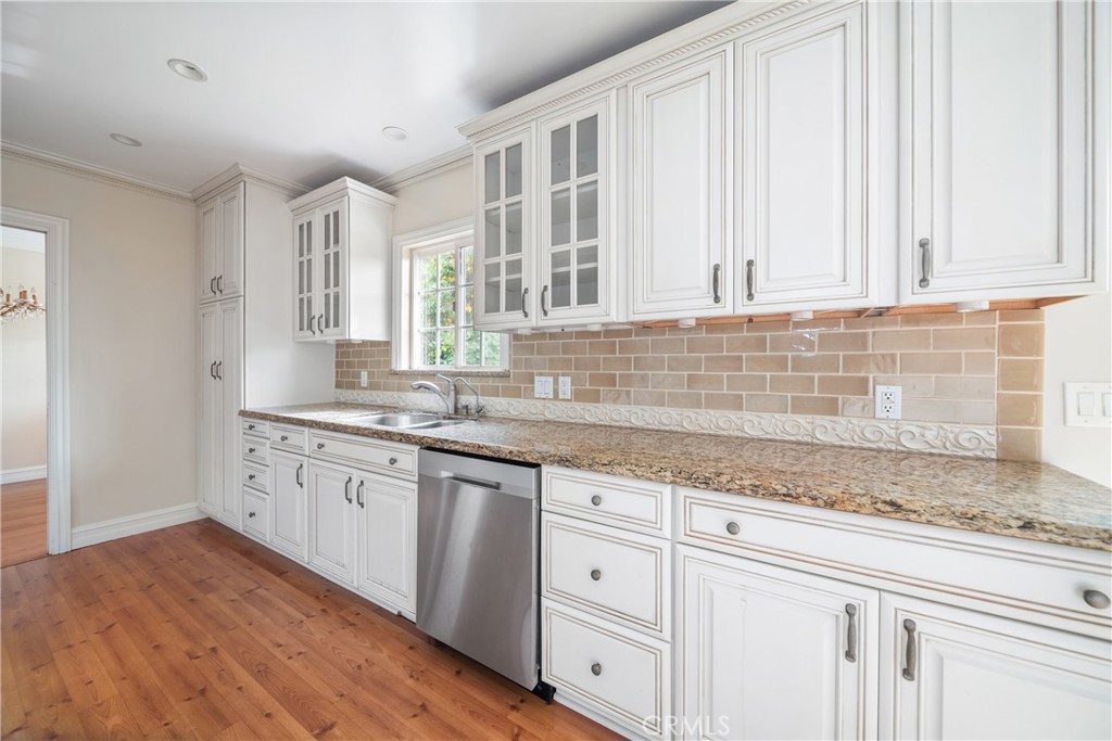 8216 Sheffield Road San Gabriel, CA 91775 - Photo 23 of 53 a kitchen with granite countertop white cabinets and sink