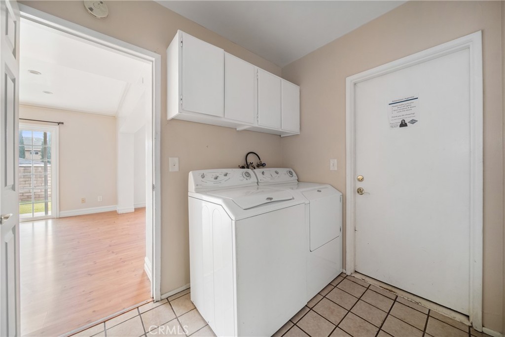 8216 Sheffield Road San Gabriel, CA 91775 - Photo 33 of 53 a utility room with cabinets washer and dryer