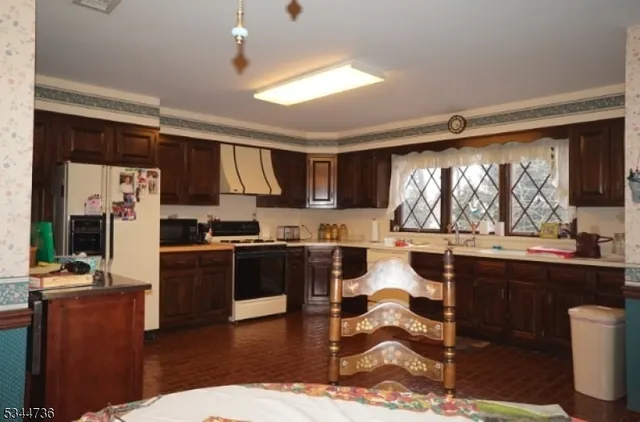 a living room with stainless steel appliances kitchen island granite countertop furniture a rug and a view of kitchen