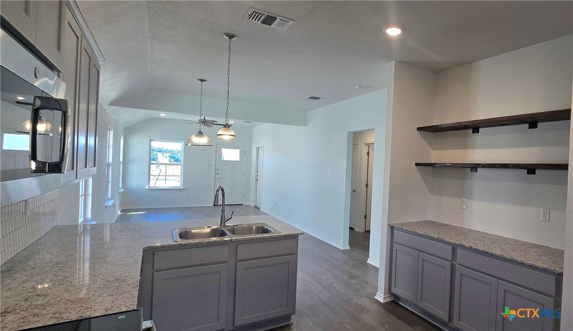 342 Monty Road Copperas Cove, TX 76522 - Photo 3 of 15 a kitchen with kitchen island a sink stainless steel appliances and cabinets