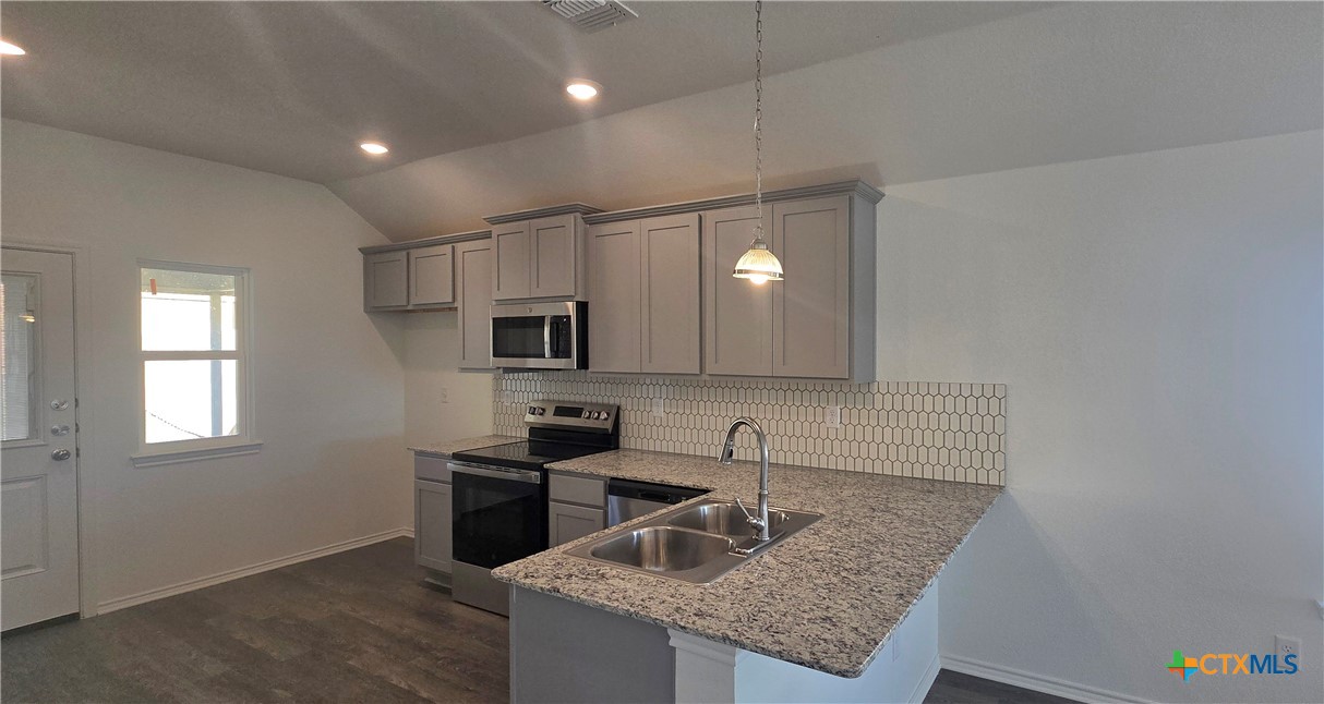 342 Monty Road Copperas Cove, TX 76522 - Photo 5 of 15 a kitchen with granite countertop a sink stainless steel appliances and cabinets
