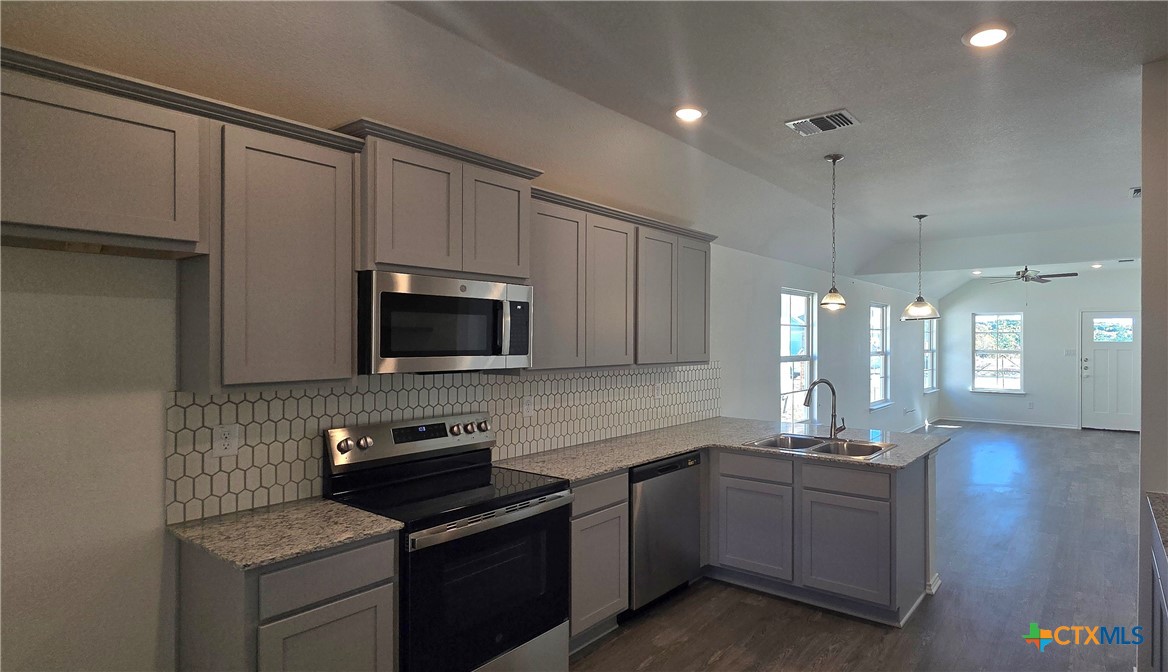 342 Monty Road Copperas Cove, TX 76522 - Photo 6 of 15 a kitchen with a sink stove and microwave