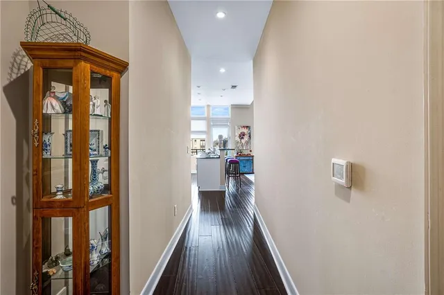 a view of a hallway with wooden floor and staircase